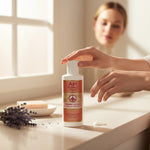 Bienenprodukte Shop Api Royale body lotion with honey and royal jelly on a counter with a woman in the background.